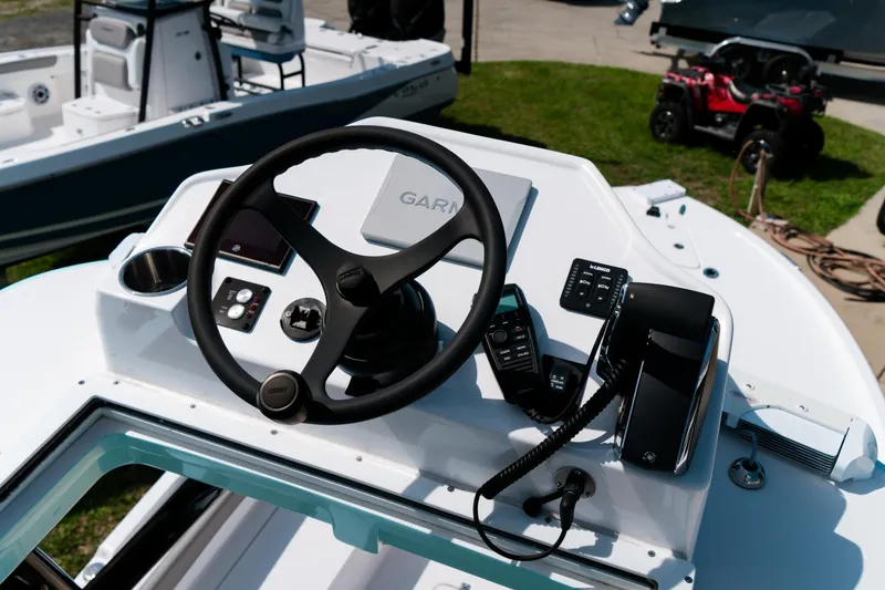 Slide: The Image of 2025 Caymas 28 HB boat dashboard with steering wheel and navigation controls. - 37