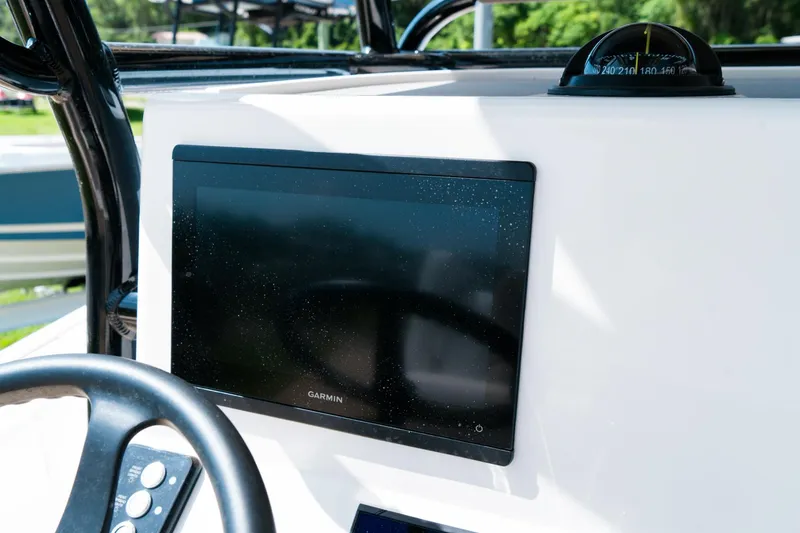 Slide: The Image of 2025 Caymas 28 HB boat dashboard with Garmin display and compass. - 39