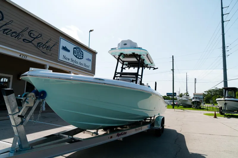 Slide: The Image of 2025 Caymas 28 HB boat on trailer outside a store, ready for transport. - 4