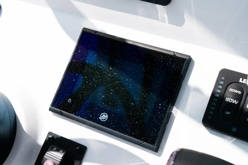 Slide: The Image of 2025 Caymas 28 HB boat dashboard with modern control panel and sleek design. - 42