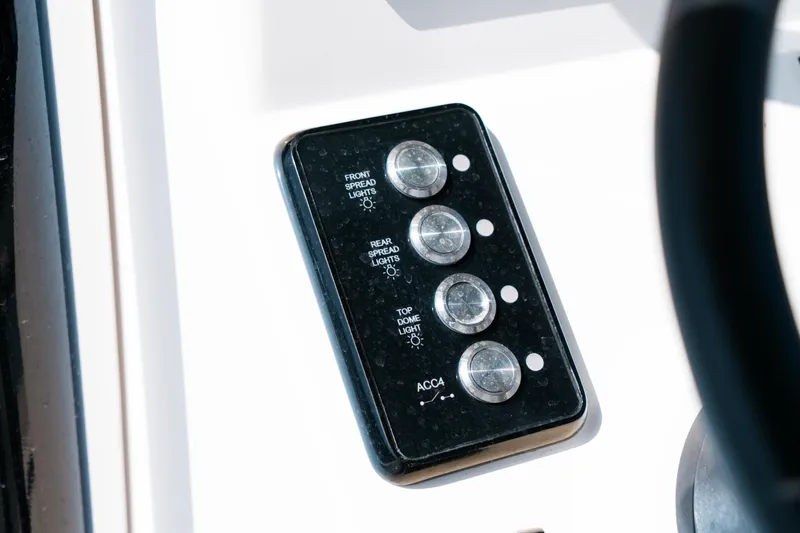 Slide: The Image of Control panel on 2025 Caymas 28 HB boat dashboard with labeled switches. - 43