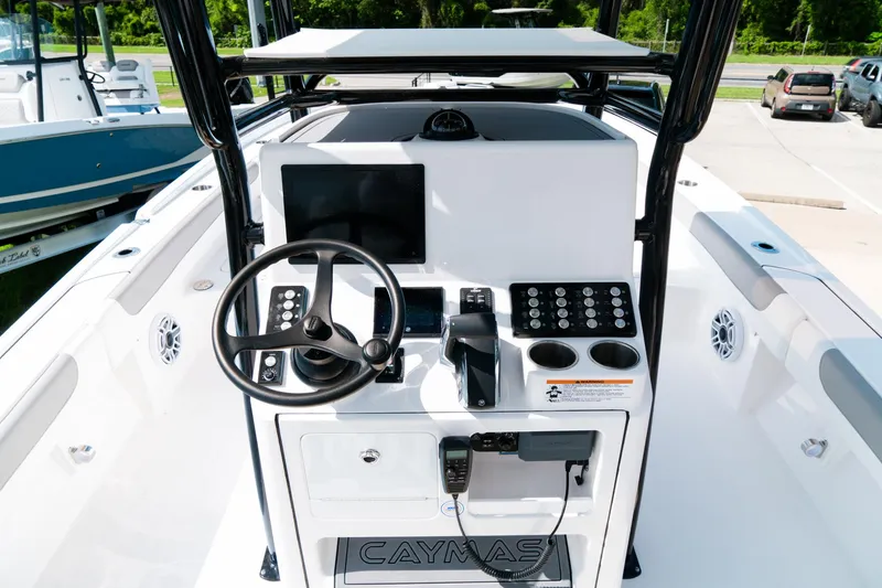Slide: The Image of 2025 Caymas 28 HB boat dashboard with steering wheel and control panel. - 44