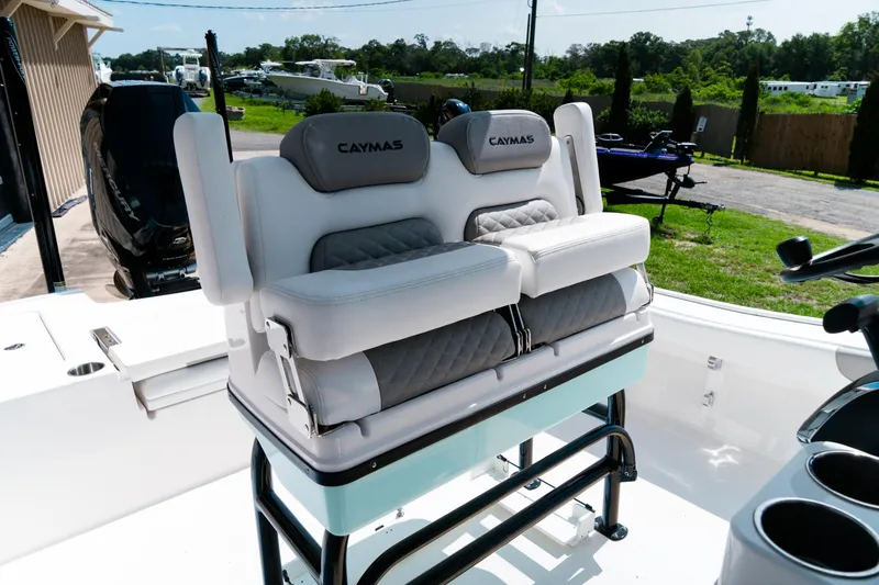 Slide: The Image of 2025 Caymas 28 HB boat seating with cushioned backrests, outdoor setting. - 49