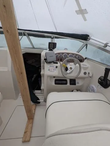 Slide: The Image of 1999 Sea Ray 215 Express Cruiser cockpit with steering wheel and dashboard controls. - 12