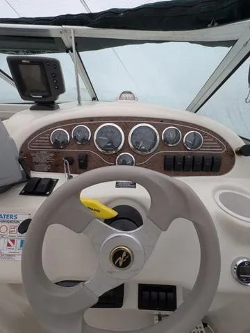 Slide: The Image of 1999 Sea Ray 215 Express Cruiser dashboard with steering wheel and instrument panel. - 14