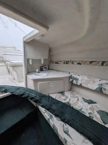 Slide: The Image of Interior cabin of 1999 Sea Ray 215 Express Cruiser with sink and seating area. - 17