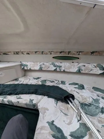 Slide: The Image of Interior cabin of a 1999 Sea Ray 215 Express Cruiser with floral upholstery. - 18