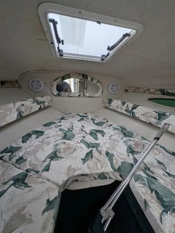 Slide: The Image of 1999 Sea Ray 215 Express Cruiser cabin with floral upholstery and overhead hatch. - 20