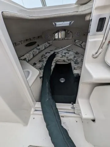 Slide: The Image of Interior cabin of 1999 Sea Ray 215 Express Cruiser with floral upholstery. - 22