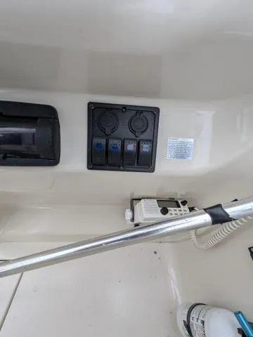 Slide: The Image of 1999 Sea Ray 215 Express Cruiser dashboard with control panel and radio. - 24