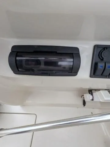 Slide: The Image of 1999 Sea Ray 215 Express Cruiser dashboard with stereo and controls. - 25