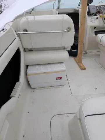 Slide: The Image of 1999 Sea Ray 215 Express Cruiser interior with seating and cooler. - 28