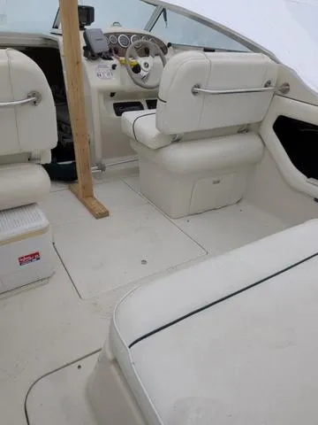 Slide: The Image of 1999 Sea Ray 215 Express Cruiser interior with white seating and dashboard. - 29