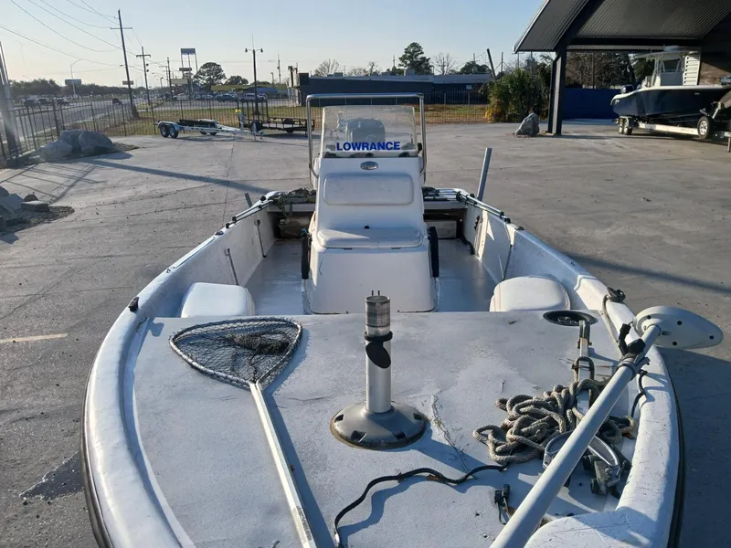 Slide: The Image of 2006 Kenner 21 boat with outboard motor and seating, displayed outdoors. - 8