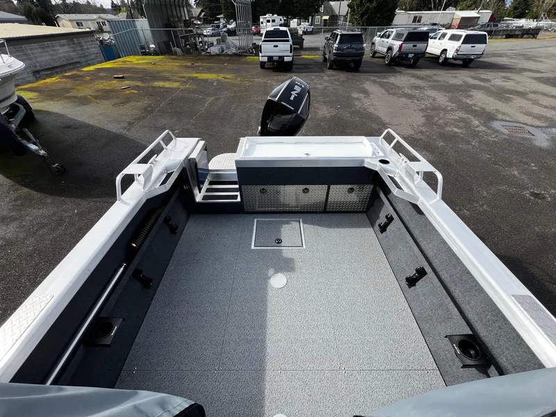 Slide: The Image of 2025 Thunder Jet 210 Luxor boat interior, spacious deck, parked outdoors. - 20