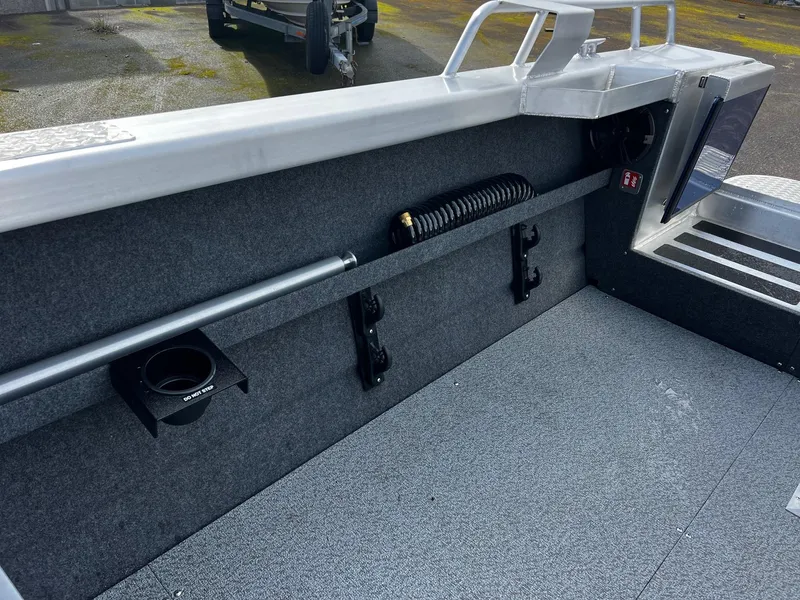 Slide: The Image of Interior view of 2025 Thunder Jet 210 Luxor boat, featuring storage compartments and carpeted flooring. - 21