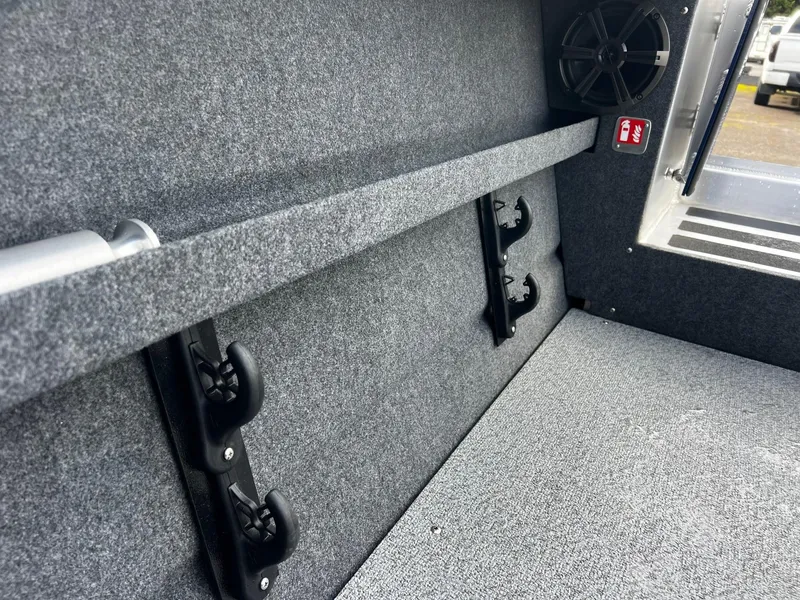 Slide: The Image of Interior of 2025 Thunder Jet 210 Luxor boat, featuring carpeted walls and speaker. - 23