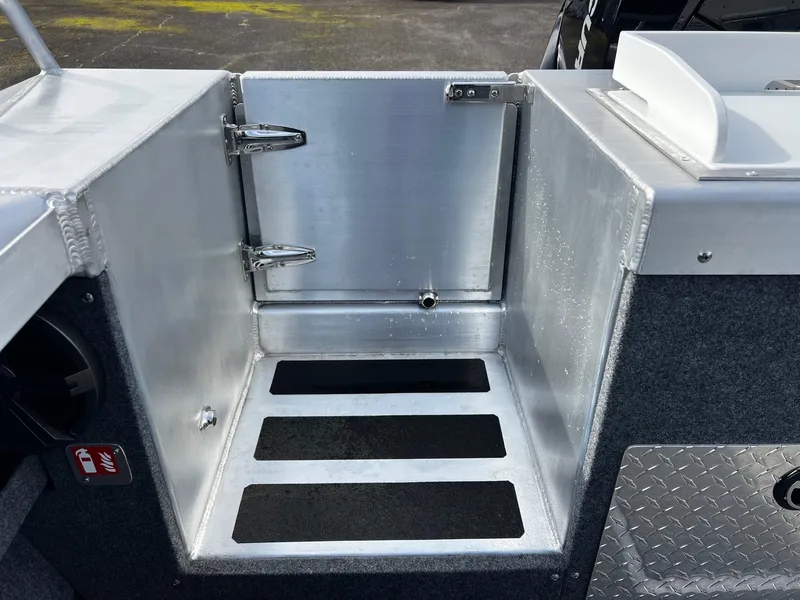 Slide: The Image of 2025 Thunder Jet 210 Luxor boat storage compartment with metal finish and secure latch. - 25