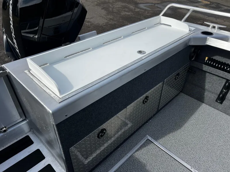 Slide: The Image of 2025 Thunder Jet 210 Luxor boat interior with storage compartments and non-slip flooring. - 27