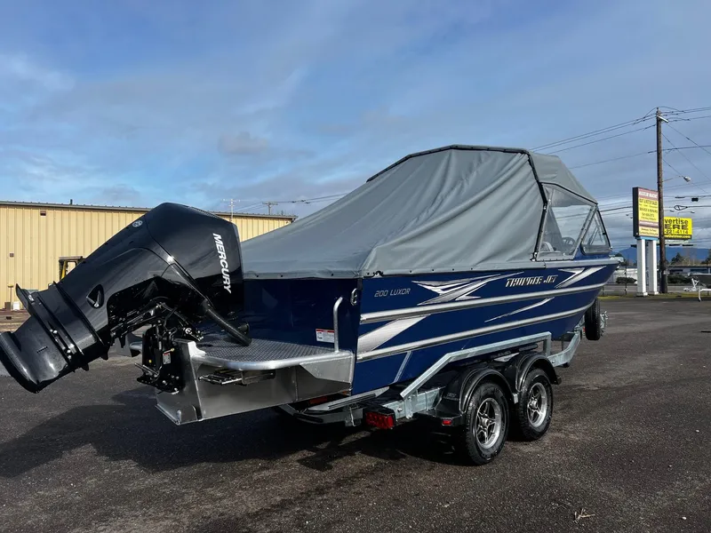 Slide: The Image of 2025 Thunder Jet 210 Luxor boat with cover and Mercury outboard motor. - 3