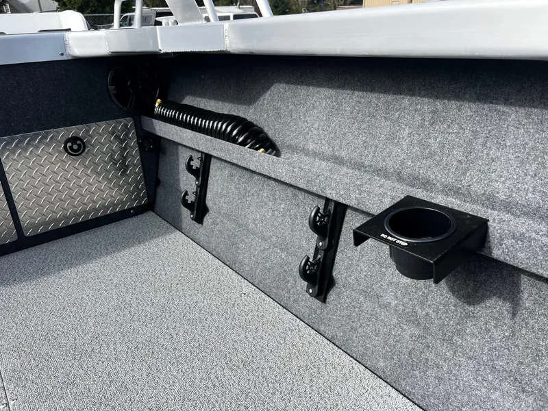 Slide: The Image of 2025 Thunder Jet 210 Luxor interior with cup holder and storage features. - 32