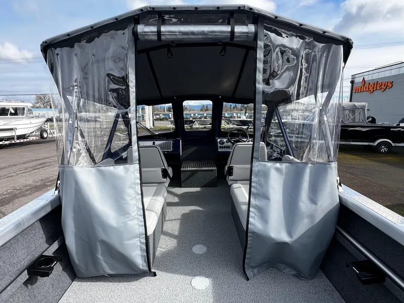 Slide: The Image of 2025 Thunder Jet 210 Luxor boat interior with seating and protective canopy. - 38