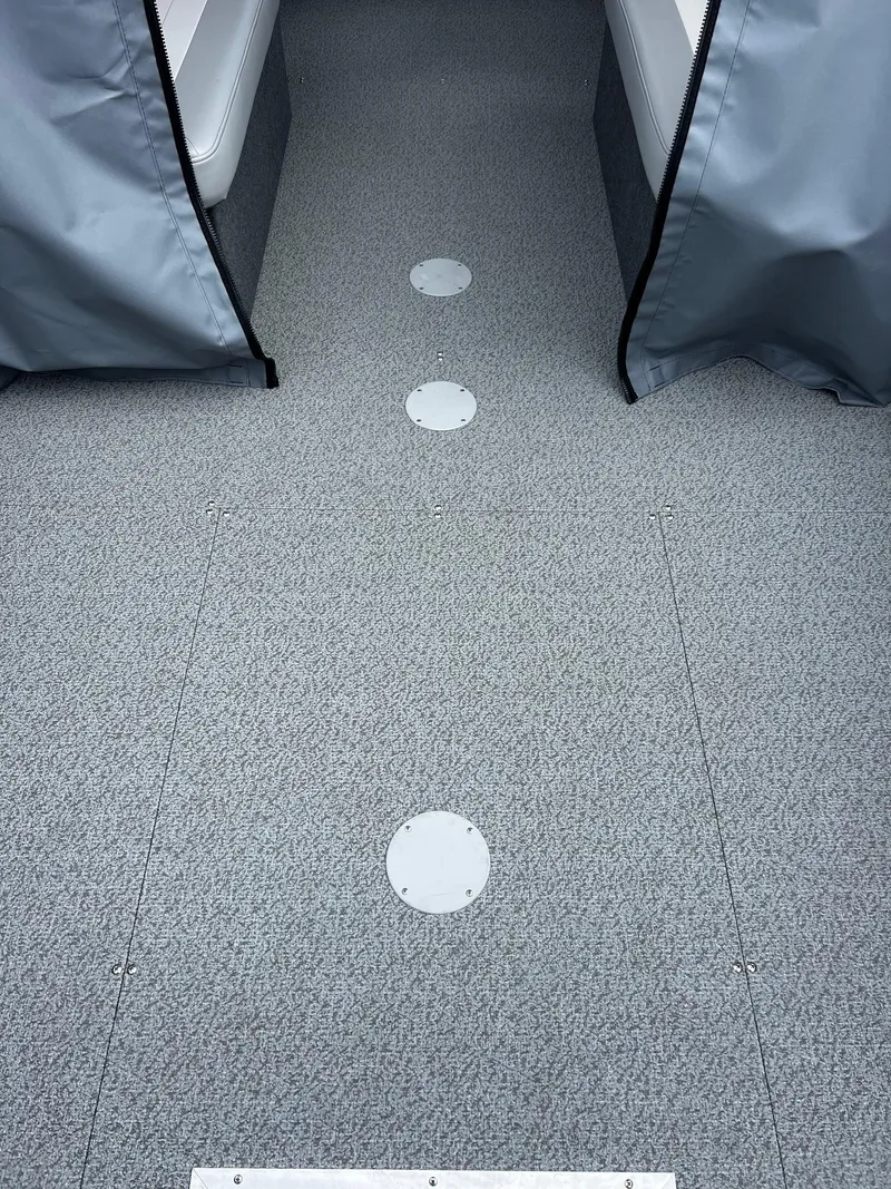 Slide: The Image of Interior view of 2025 Thunder Jet 210 Luxor boat with gray carpet flooring. - 39