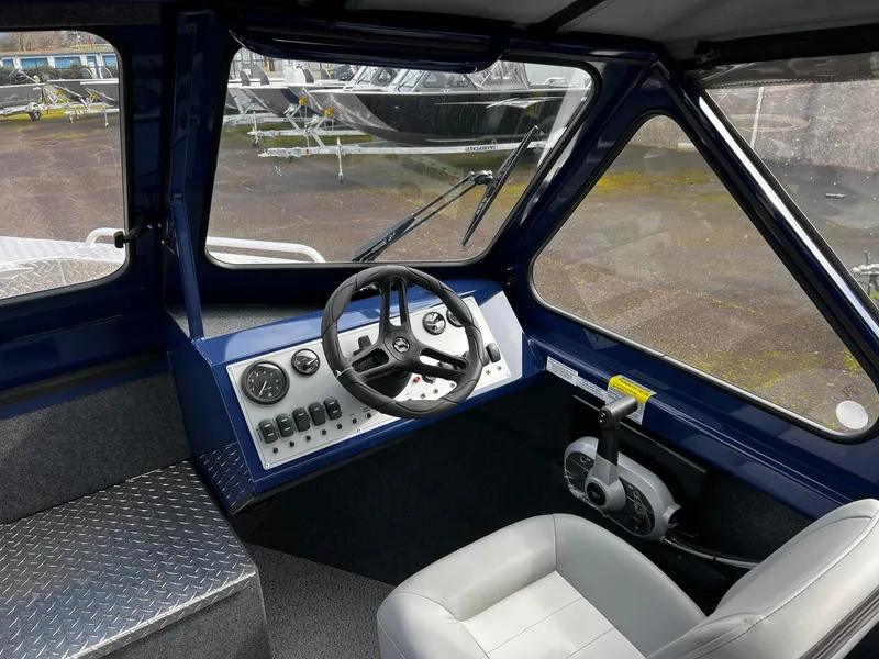 Slide: The Image of Interior of 2025 Thunder Jet 210 Luxor boat, featuring steering wheel and control panel. - 46