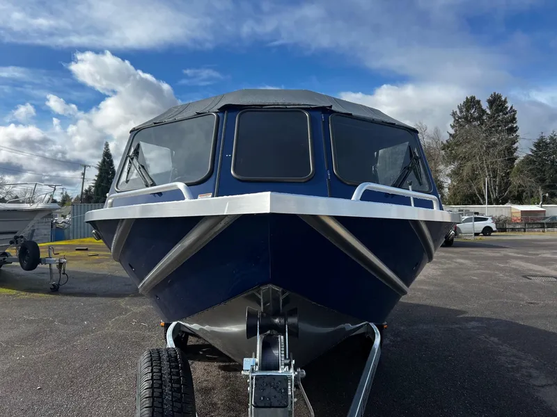 Slide: The Image of 2025 Thunder Jet 210 Luxor boat on trailer, front view under cloudy sky. - 7