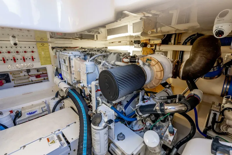 Slide: The Image of Engine room of a 2005 Cabo 40 Flybridge yacht, showcasing mechanical components. - 32