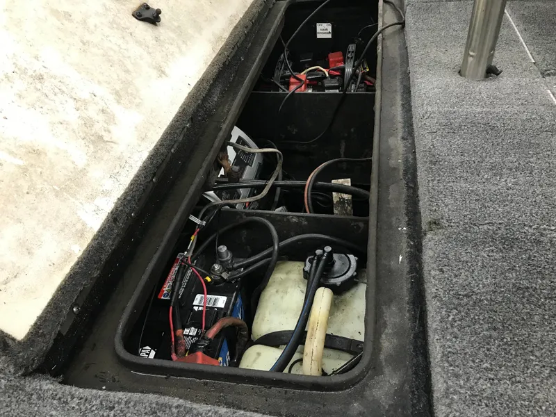 Slide: The Image of 2004 Ranger 519 VX/VS boat battery compartment with wiring and components. - 11