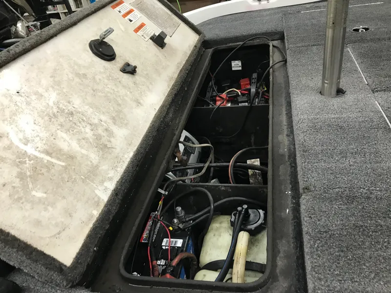 Slide: The Image of 2004 Ranger 519 VX/VS boat storage compartment with visible wiring and equipment. - 12