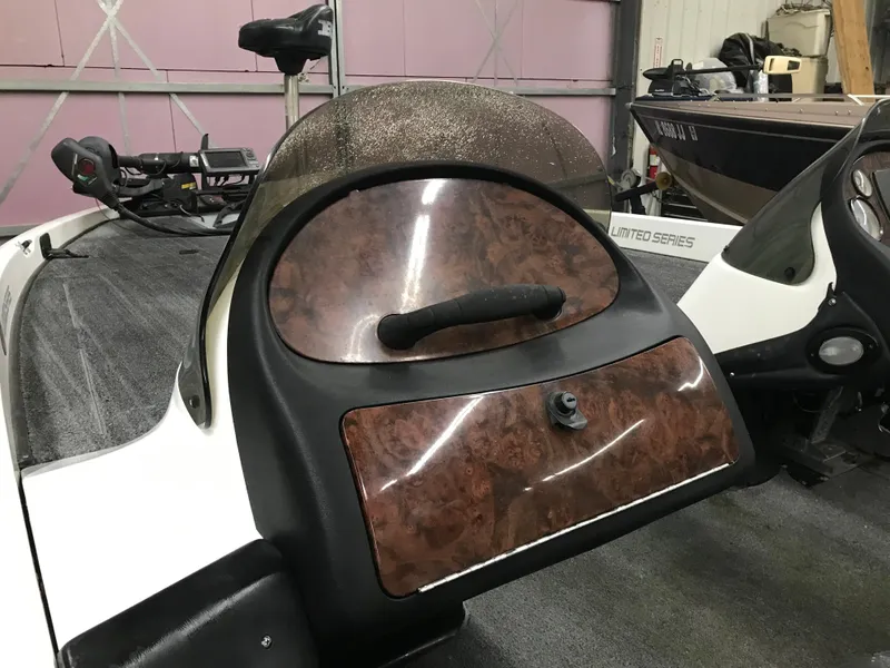 Slide: The Image of 2004 Ranger 519 VX/VS boat dashboard with woodgrain finish and steering handle. - 19