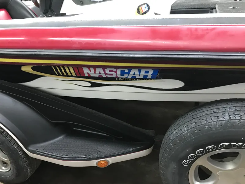 Slide: The Image of 2004 Ranger 519 VX/VS boat with NASCAR-themed graphics and Goodyear tires. - 2