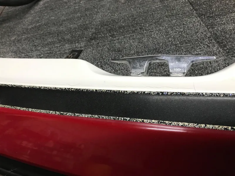 Slide: The Image of 2004 Ranger 519 VX/VS boat cleat on red and black deck. - 21