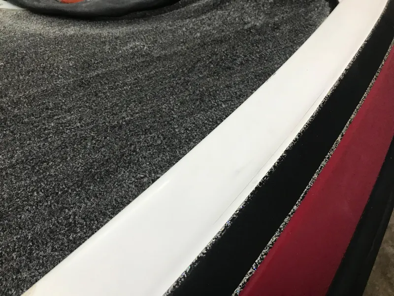 Slide: The Image of Close-up of 2004 Ranger 519 VX/VS boat interior with textured surface and red accents. - 26
