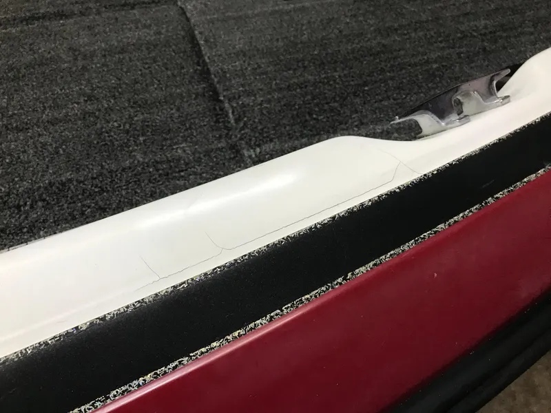 Slide: The Image of Close-up of a 2004 Ranger 519 VX/VS boat interior with red and black trim. - 27