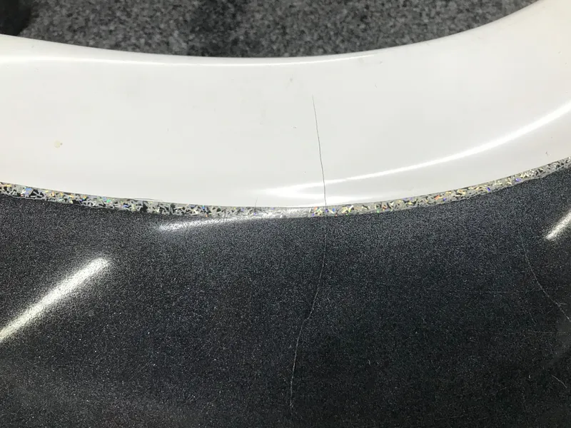 Slide: The Image of Close-up of a 2004 Ranger 519 VX/VS boat surface with visible crack. - 34