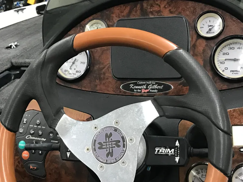 Slide: The Image of Steering wheel of 2004 Ranger 519 VX/VS boat with wood grain dashboard and gauges. - 37