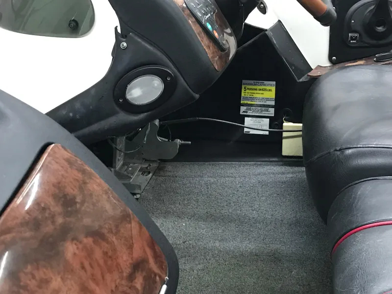 Slide: The Image of 2004 Ranger 519 VX/VS boat interior with wood accents and seating. - 38