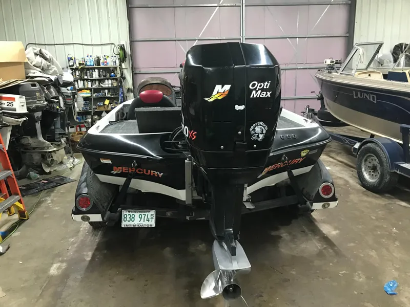 Slide: The Image of 2004 Ranger 519 VX/VS boat with Mercury OptiMax engine in a garage. - 4