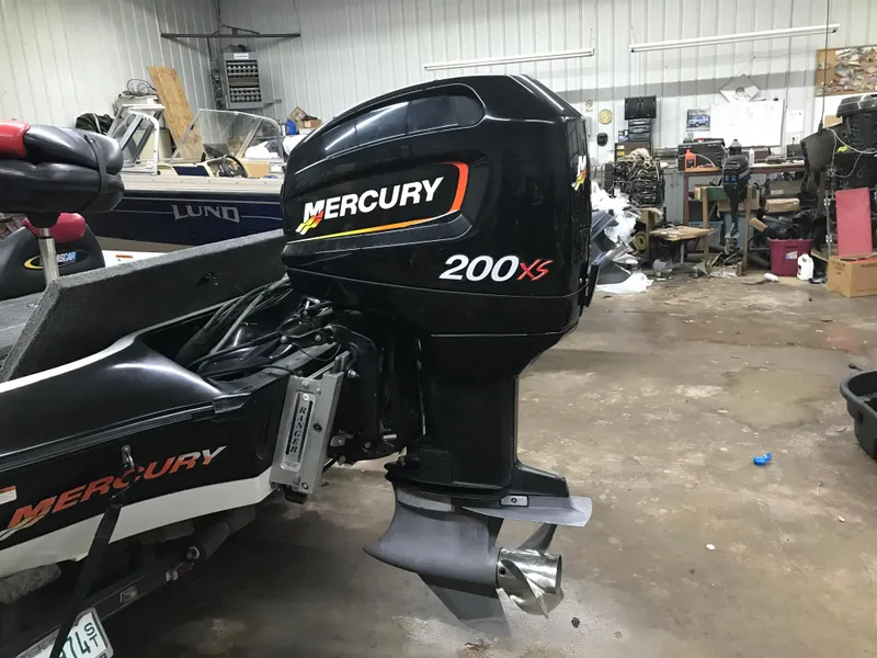 Slide: The Image of 2004 Ranger 519 VX/VS boat with Mercury 200 XS outboard motor in a garage. - 5