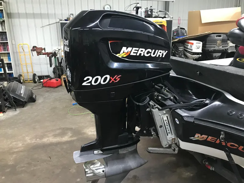 Slide: The Image of 2004 Ranger 519 VX/VS with Mercury 200 XS outboard motor in a garage setting. - 6