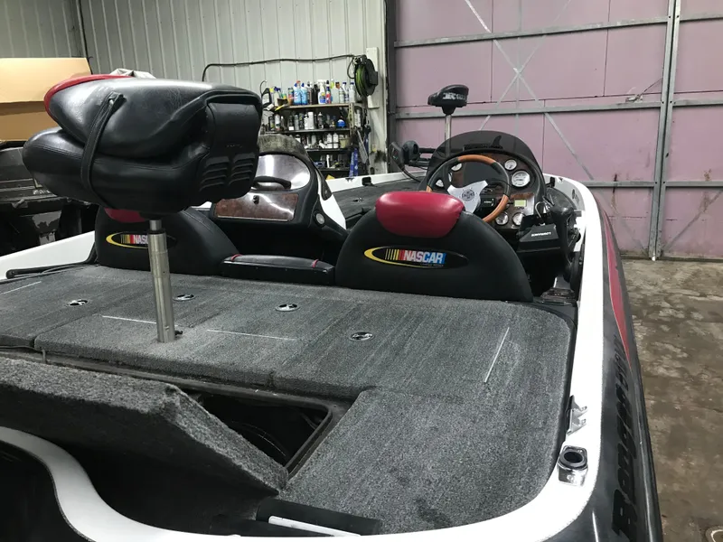 Slide: The Image of 2004 Ranger 519 VX/VS boat interior with NASCAR-themed seats in a garage setting. - 7