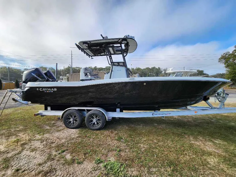 Slide: The Image of 2025 Caymas 281 HB boat on trailer, black hull, dual engines, outdoor setting. - 0