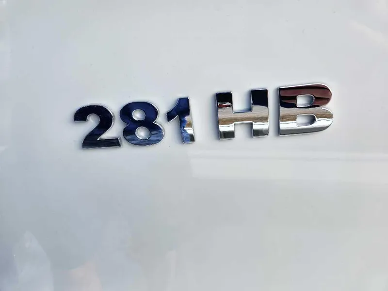 Slide: The Image of 2025 Caymas 281 HB model emblem on white surface. - 12