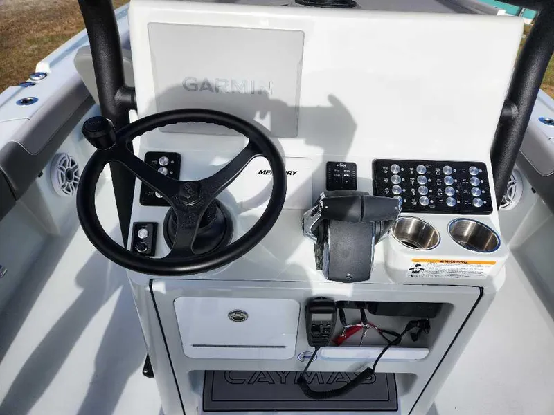Slide: The Image of 2025 Caymas 281 HB boat console with steering wheel and control panel. - 16