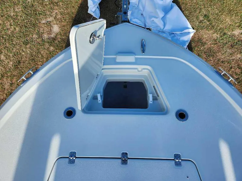 Slide: The Image of Open storage compartment on 2025 Caymas 281 HB boat deck, showing interior space. - 2