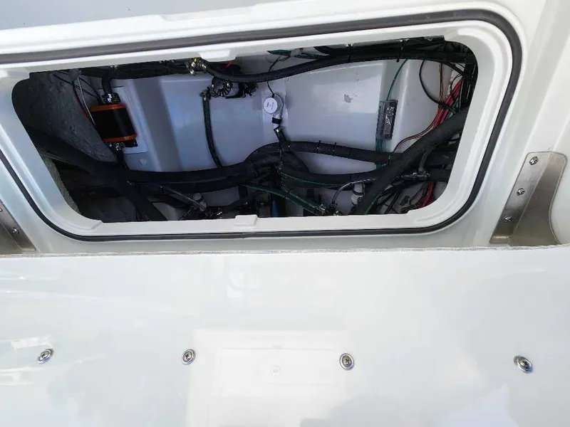 Slide: The Image of 2025 Caymas 281 HB boat interior compartment with visible wiring and components. - 20