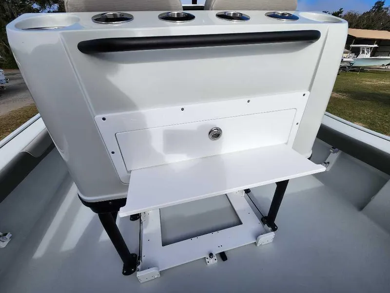 Slide: The Image of 2025 Caymas 281 HB boat console with cup holders and storage compartment. - 23
